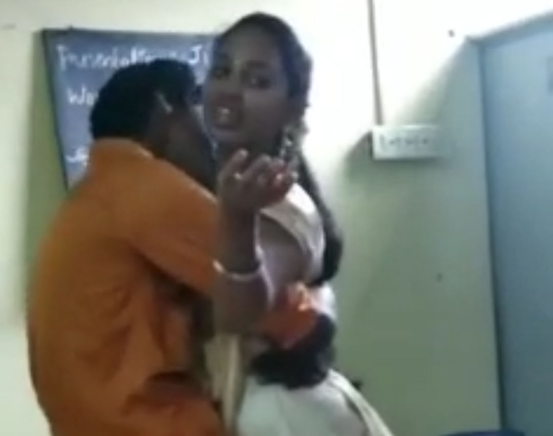 Boy & Girl Kissing In Classroom